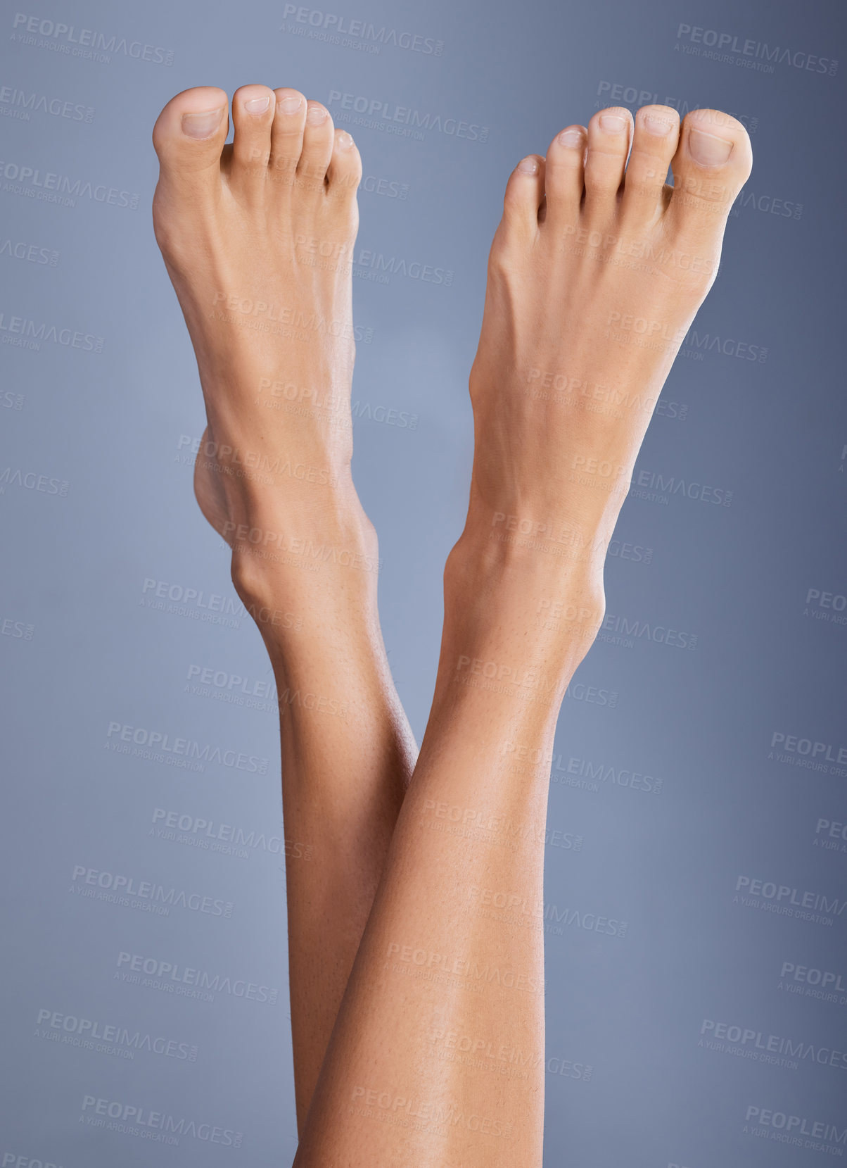 Buy stock photo Shot of a woman with her feet in the air