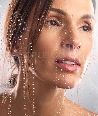 Buy stock photo Studio shot of a beautiful young woman taking a shower against a grey background