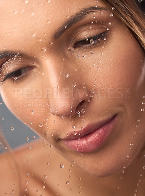 Buy stock photo Studio shot of a beautiful young woman taking a shower against a grey background