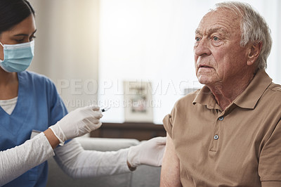 Buy stock photo Shot of a young female nurse giving an elderly man the vaccine at home