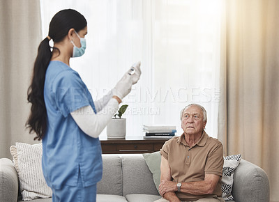 Buy stock photo Shot of a young female nurse giving an elderly man the vaccine at home