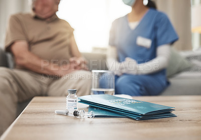 Buy stock photo Shot of a vaccine and pamphlet on a table during a checkup at home