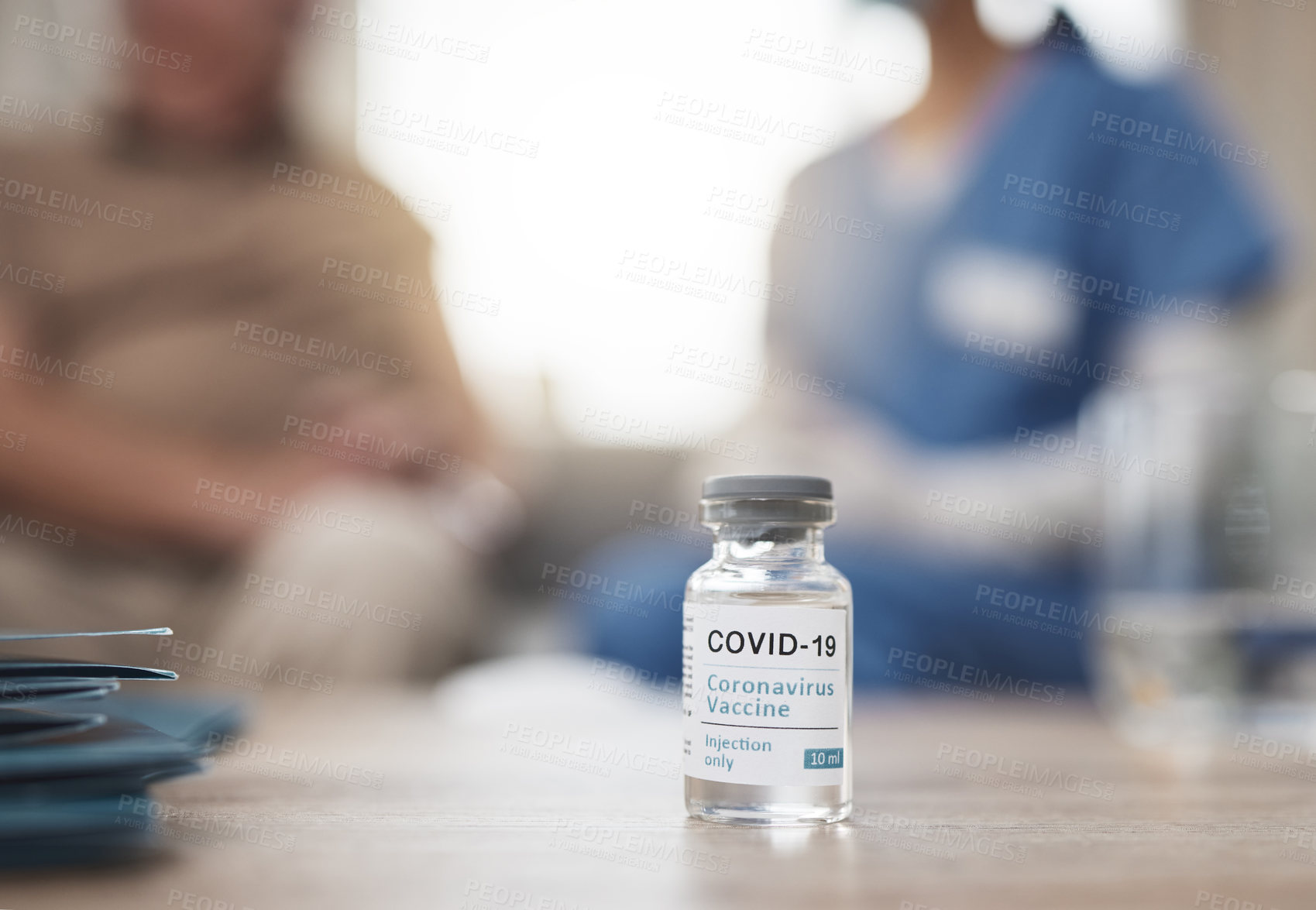 Buy stock photo Shot of a vaccine tube on a table during a checkup at home