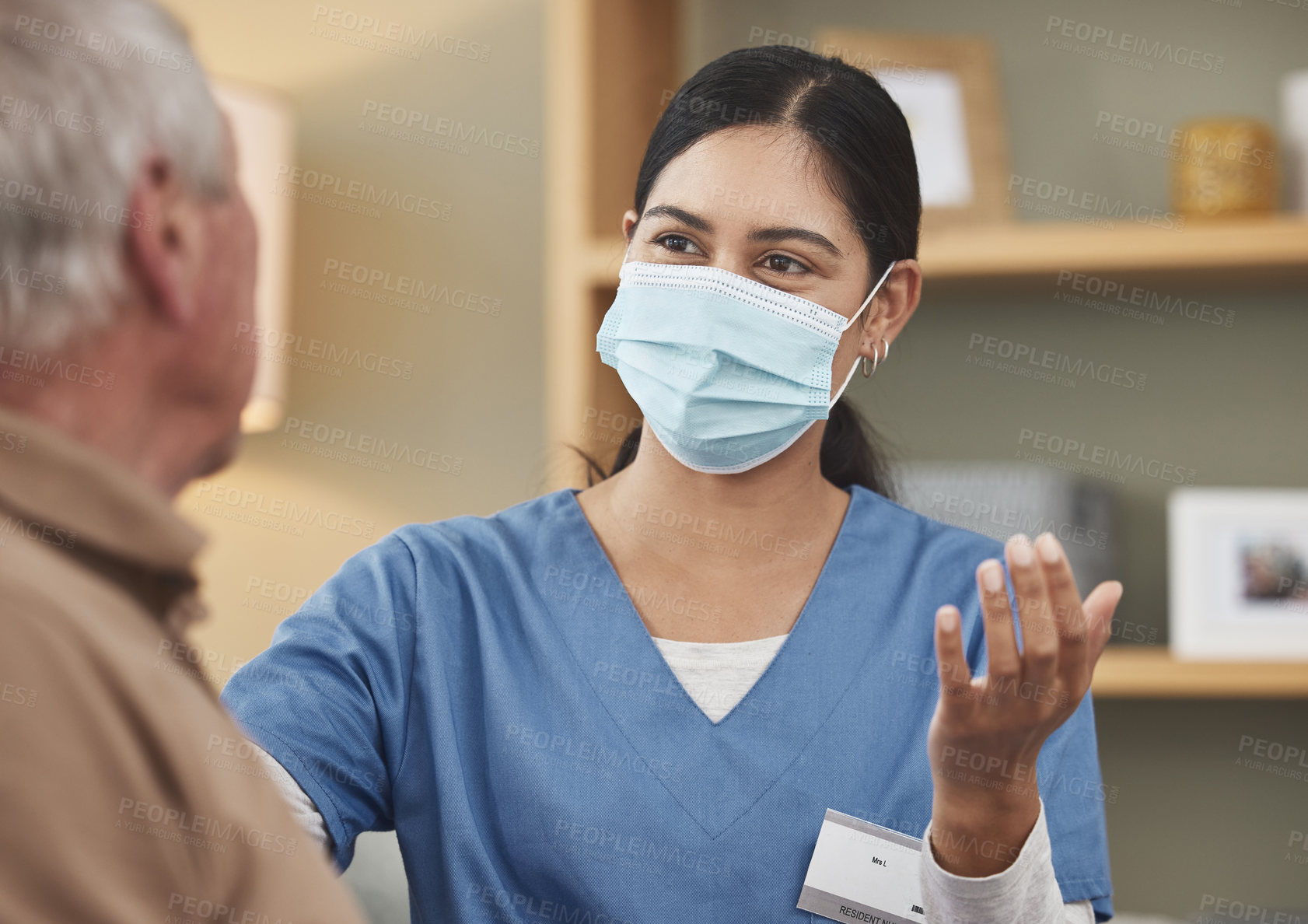 Buy stock photo Shot of a young female nurse having a checkup with an elderly patient at home