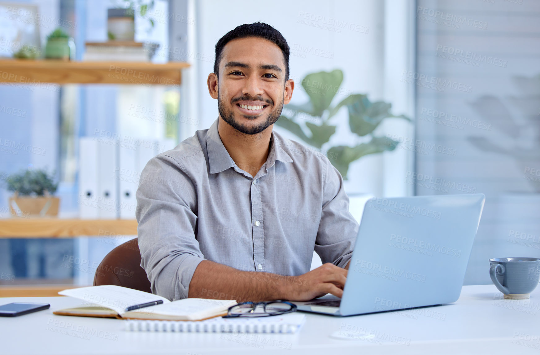 Buy stock photo Portrait of a young businesswoman working on a laptop in an office