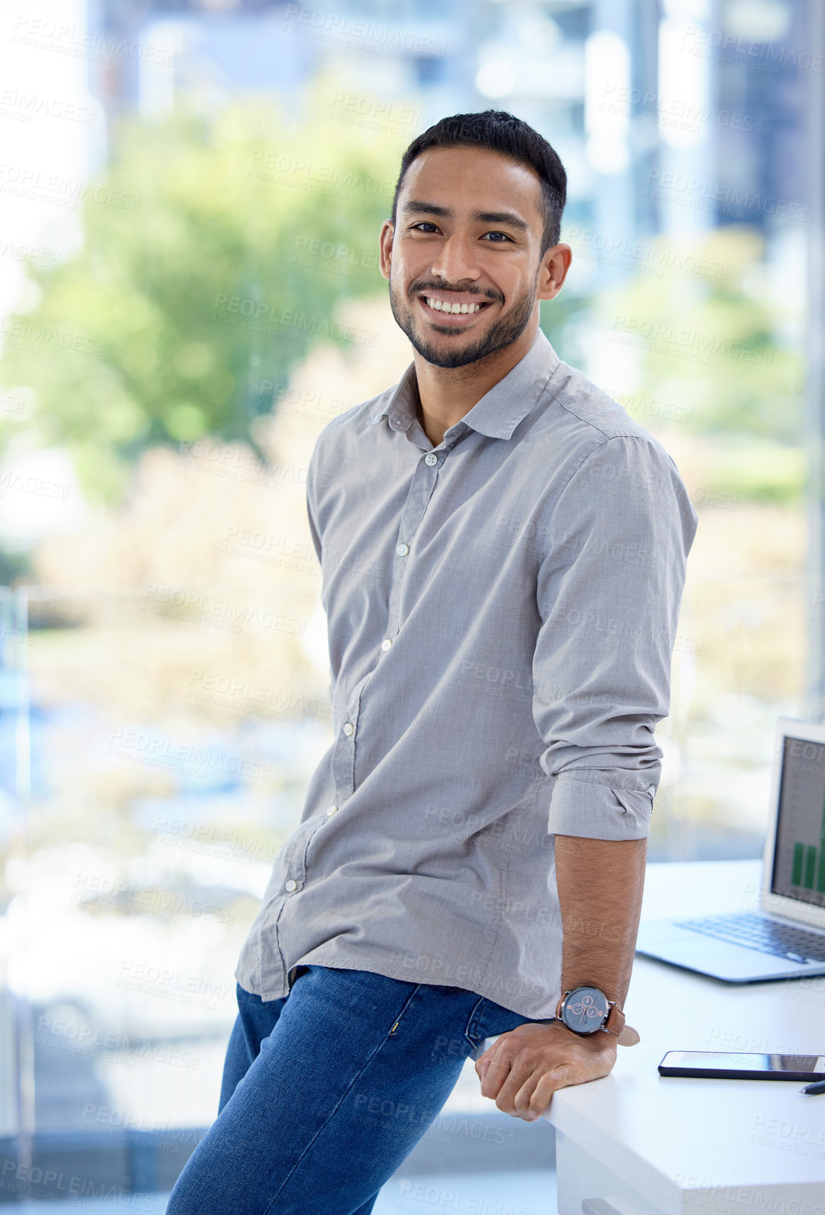 Buy stock photo Portrait of a confident young businessman standing in an office