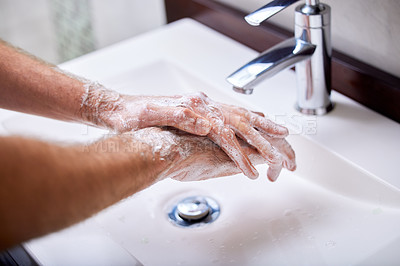 Buy stock photo Closeup of man washing hands with soap in bathroom sink at home and cleaning skin from germs, covid bacteria and protecting against spread of diseases. Routine hygiene and safety against flu or ebola