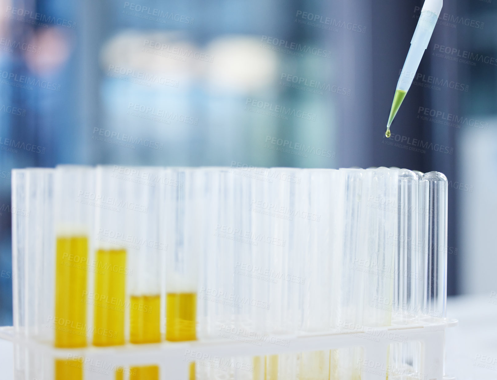Buy stock photo Shot of liquid being poured into tubes in a laboratory