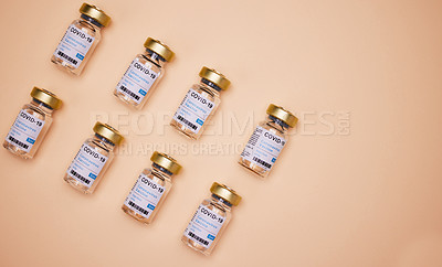 Buy stock photo Studio shot of vaccine tubes against an orange background