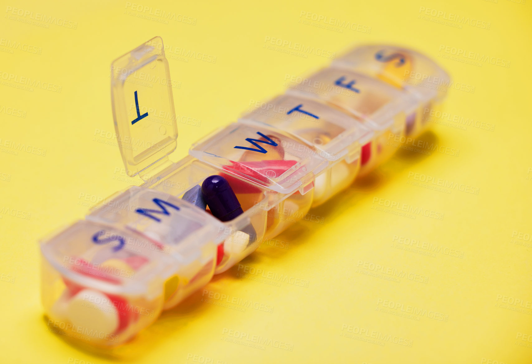 Buy stock photo Daily medicine, healthcare and pill container in studio for prescription, health or anxiety disorder on yellow background. Empty, wellness and box with drugs for depression, supplements or vitamins