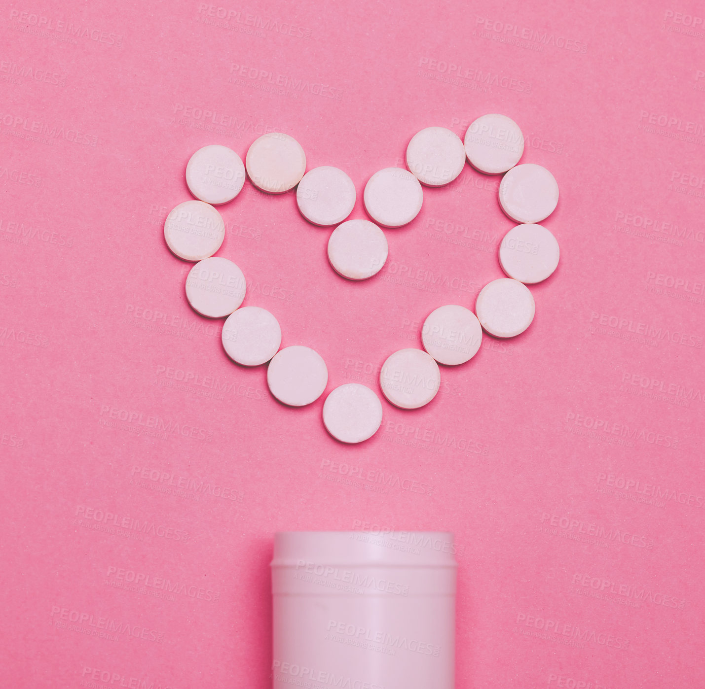 Buy stock photo Studio shot of pills forming a heart against a pink background