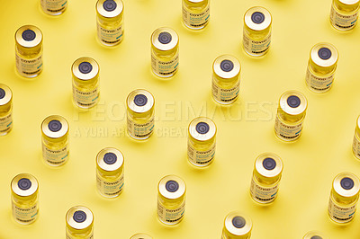 Buy stock photo Studio shot of vaccine tubes against a yellow background