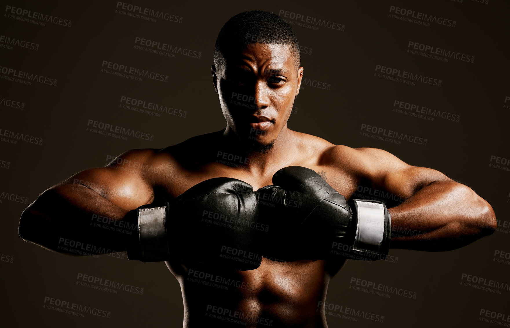 Buy stock photo Studio shot of a handsome young man boxing against a black background