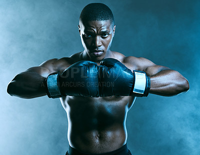 Buy stock photo Studio shot of a handsome young man boxing against a blue background