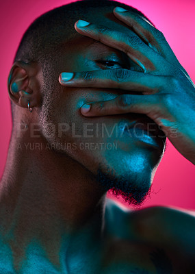 Buy stock photo Creative, portrait and peeking in studio with hand, black man and neon light for art deco and mystery. Cosmetics, male model and eye for abstract, vaporwave and aesthetics by pink background