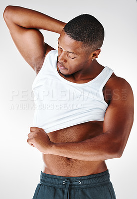 Buy stock photo Arms, fitness and African man with tshirt in studio for wellness, workout and healthcare. Clothes, abs and bodybuilder with pride for results, progress and training or sport by white background