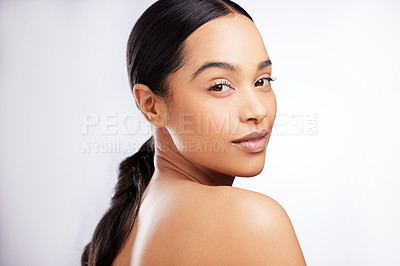Buy stock photo Studio portrait of a beautiful young woman posing against a white background