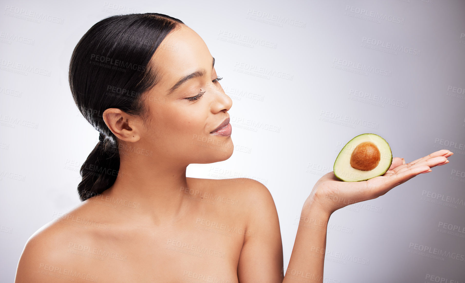 Buy stock photo Woman, studio or natural with avocado for beauty, cosmetic with transformation. Female person, white background or makeup with smile for sustainable skin care, detox for wellness or aesthetic