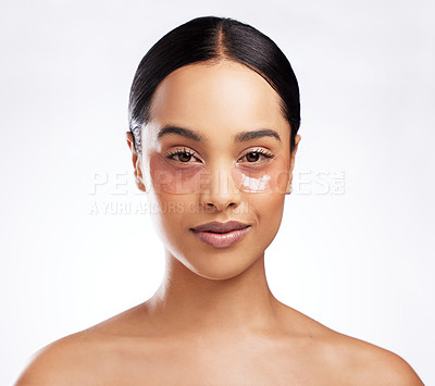 Buy stock photo Studio portrait of a beautiful young woman wearing under-eye patches against a white background