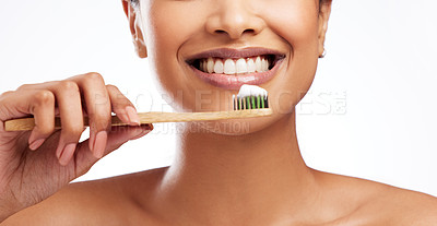 Buy stock photo Studio shot of an unrecognisable woman brushing her teeth against a white background