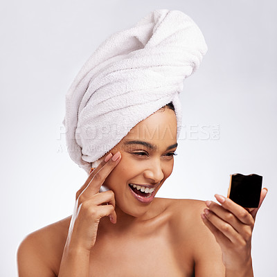 Buy stock photo Studio shot of a beautiful young woman admiring her skin in a mirror against a white background