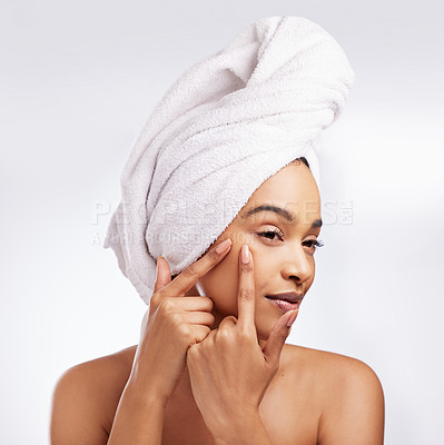 Buy stock photo Skincare, pimple and hand of woman in studio for cosmetics, natural or blemish treatment on white background. Spa, body and female model with towel for popping zit, acne breakout or wellness routine