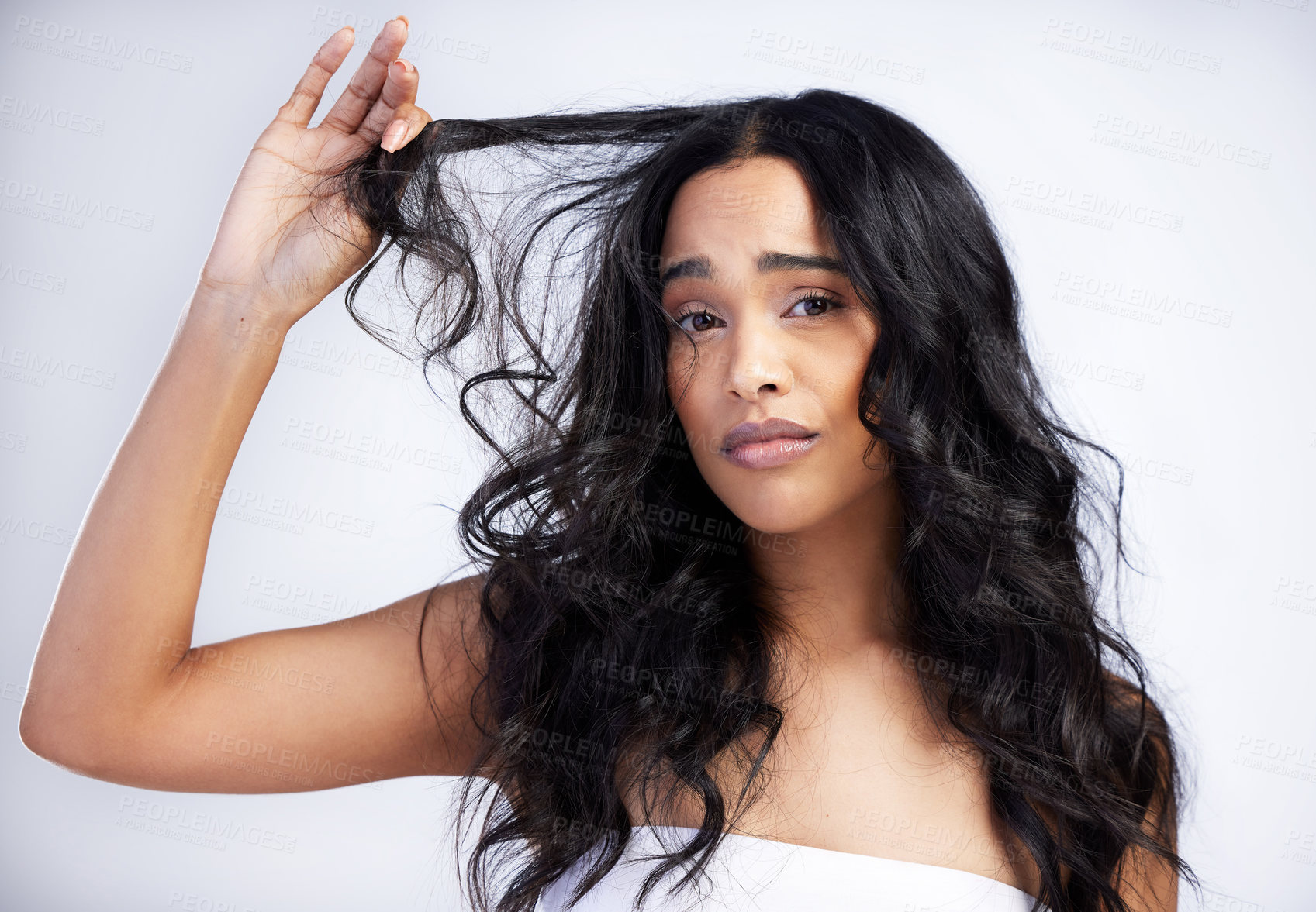 Buy stock photo Frustrated, woman and portrait for hair care in studio with loss, crisis and unhappy for treatment. Model girl, face and stress for damage and confused with change of shampoo by white background  