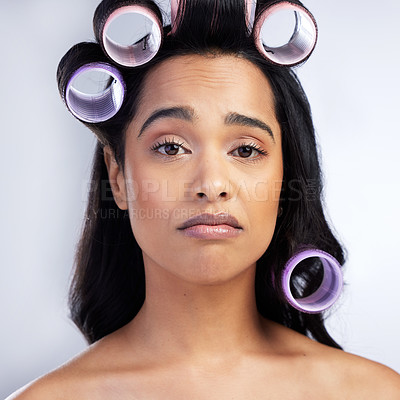 Buy stock photo Face, hair care rollers and woman with problem for transformation fail and styling mistake in studio. Portrait, girl and hairstyle disaster with curling tools for beauty crisis by white background