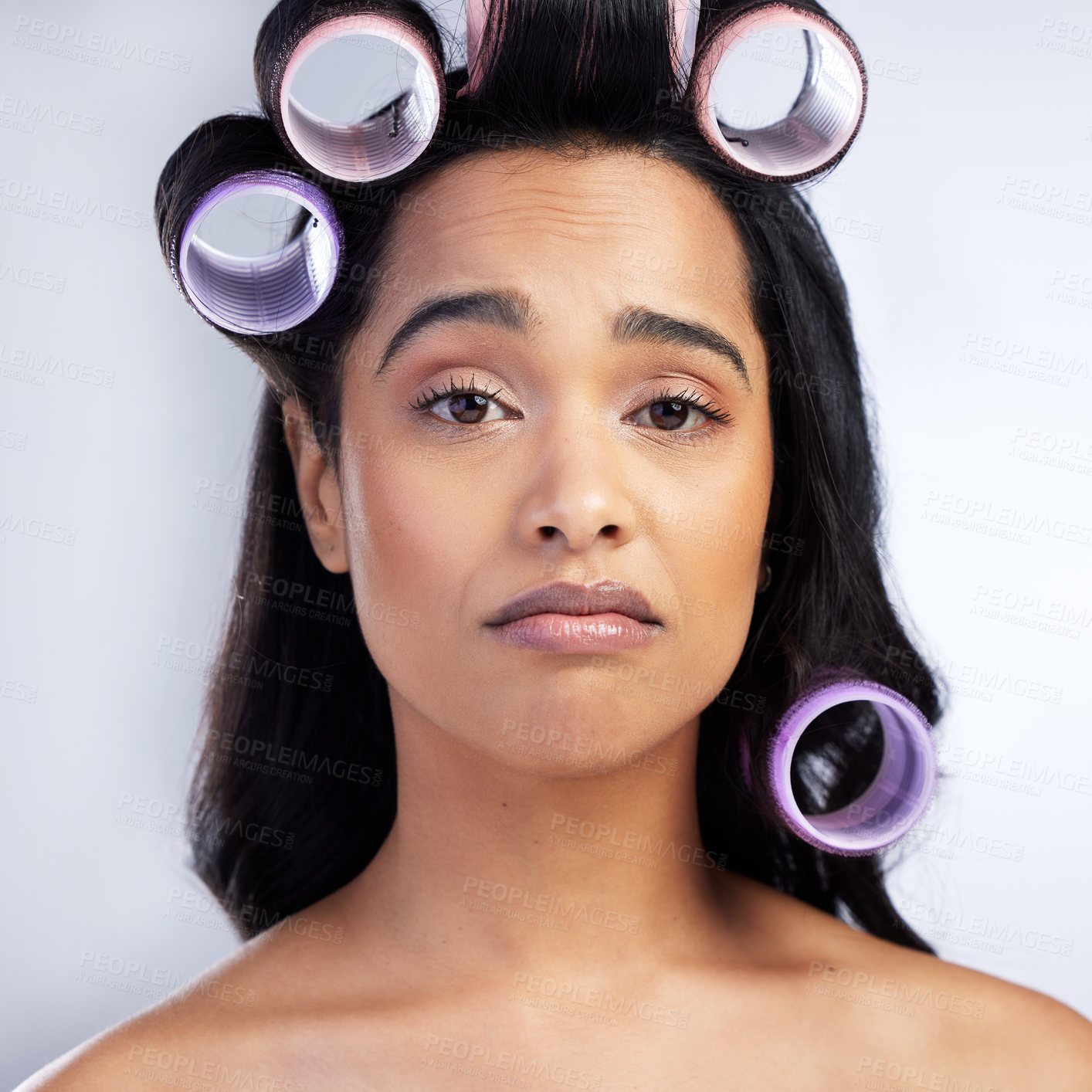 Buy stock photo Face, hair care rollers and woman with problem for transformation fail and styling mistake in studio. Portrait, girl and hairstyle disaster with curling tools for beauty crisis by white background