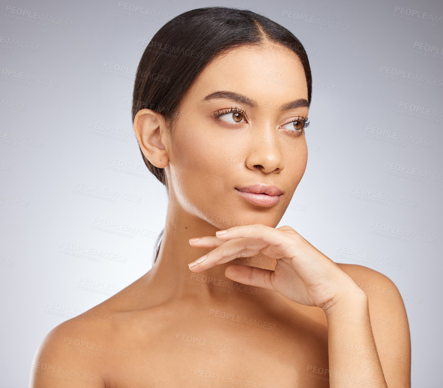 Buy stock photo Studio shot of an attractive young woman posing against a grey background