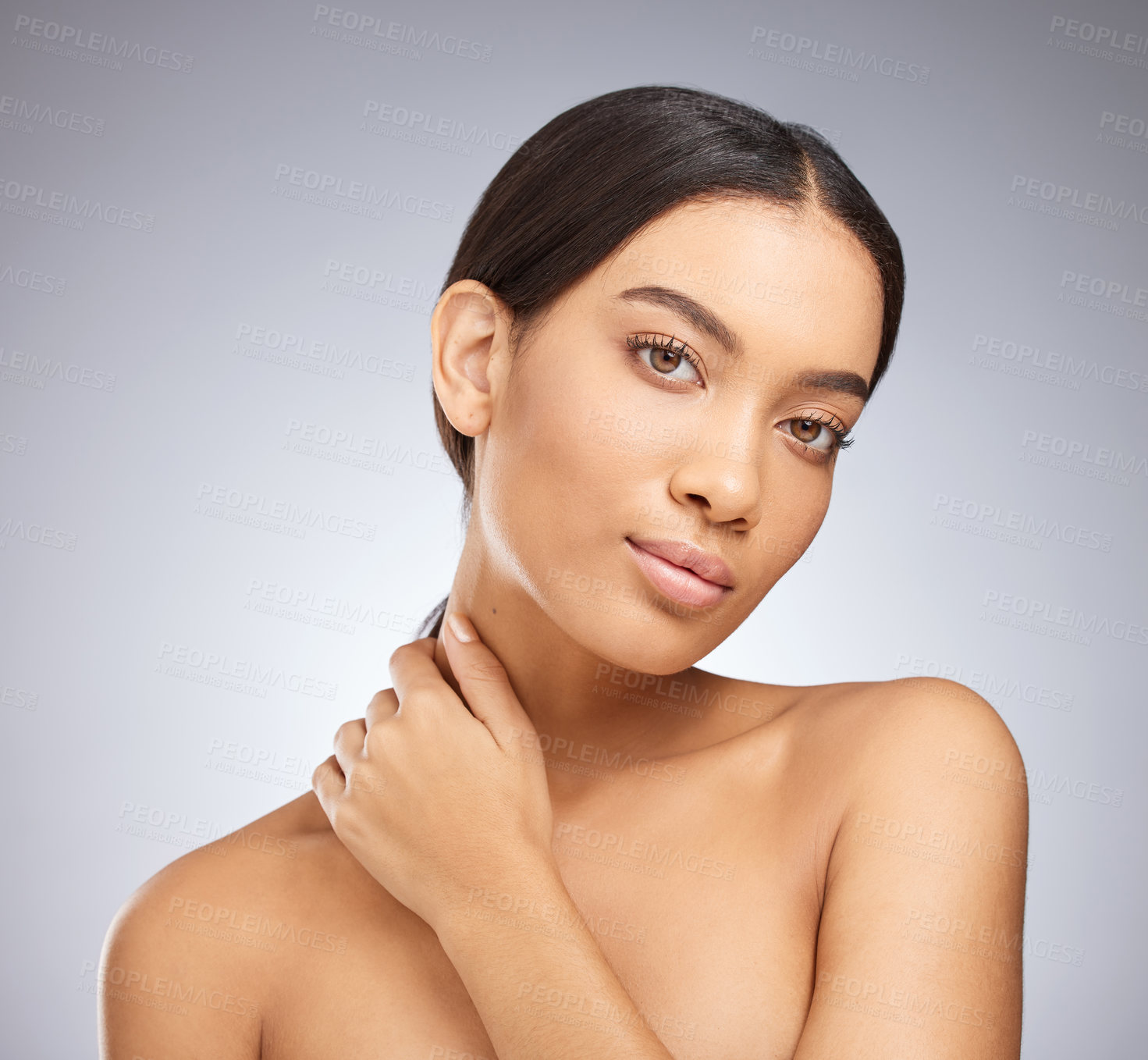 Buy stock photo Studio shot of an attractive young woman posing against a grey background