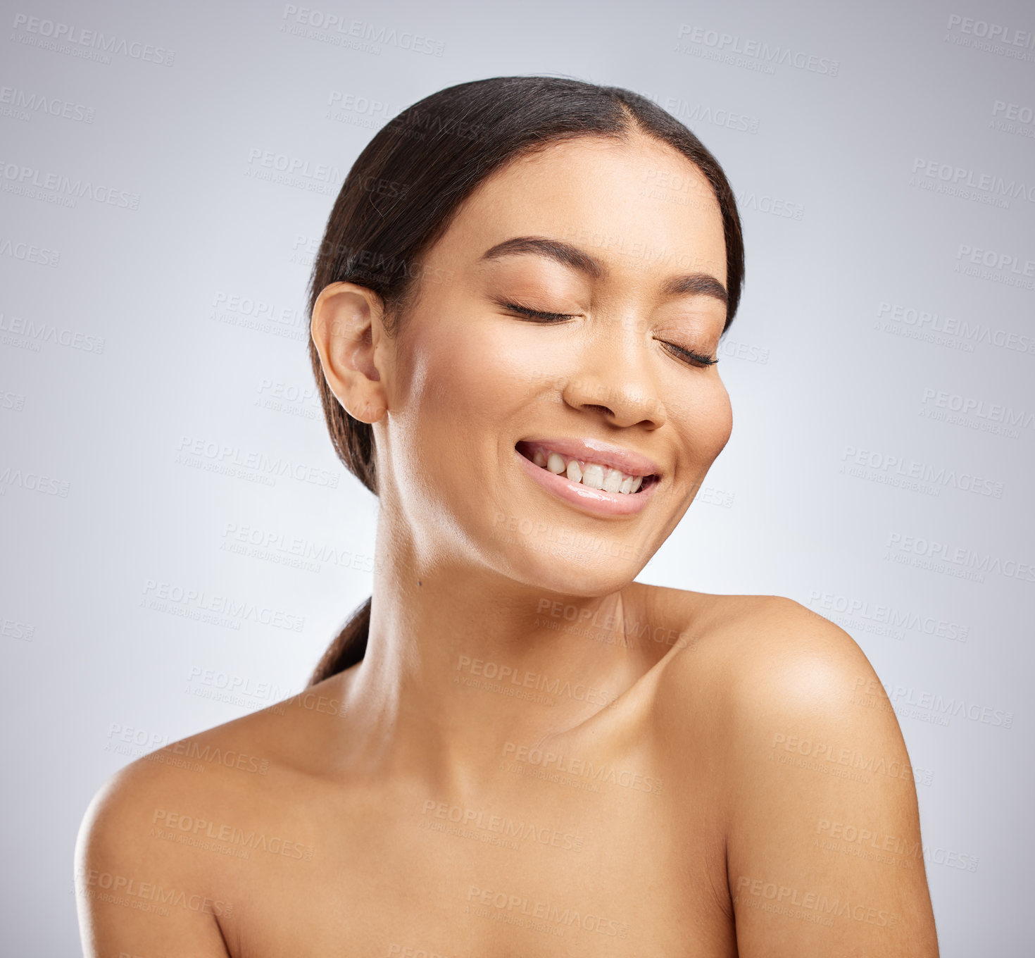 Buy stock photo Studio shot of an attractive young woman posing against a grey background