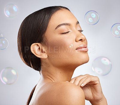 Buy stock photo Studio, bubbles and beauty for calm woman, hands and cosmetic on white background. Cosmetology, smile and confidence for relax female model, dermatology and salon treatment for skincare or wellness
