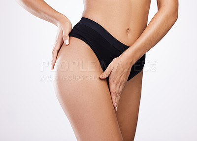 Buy stock photo Studio shot of an unrecognisable woman posing in her underwear against a white background