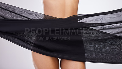 Buy stock photo Studio shot of an unrecognisable woman posing with black fabric around her waist against a white background
