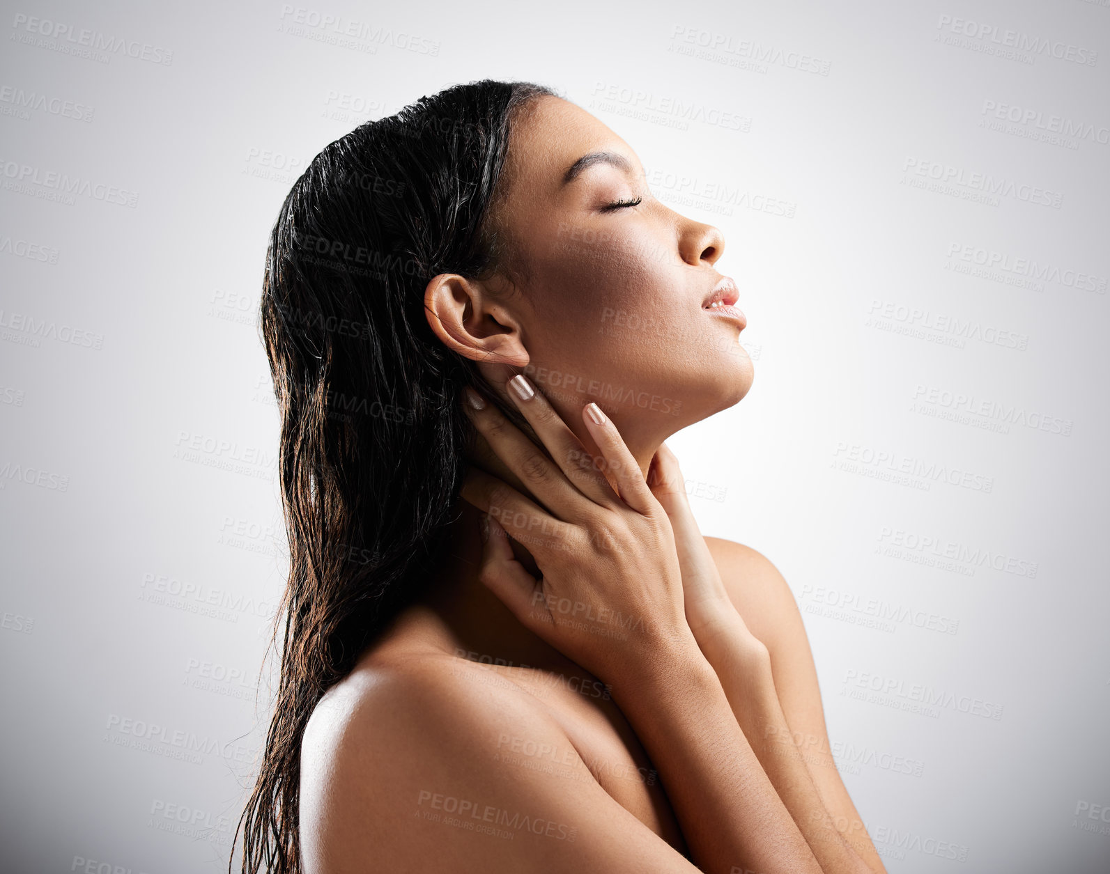 Buy stock photo Cropped shot of an attractive young woman posing in studio against a grey background