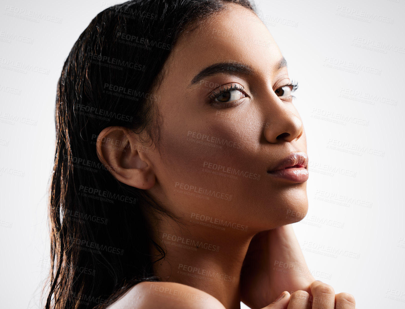 Buy stock photo Cropped portrait of an attractive young woman posing in studio against a grey background