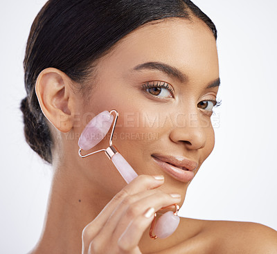 Buy stock photo Skincare, portrait or derma roller by girl in studio for facelift, cosmetics and collagen treatment on white background. Rose quartz, crystal or model with stone facial, lymphatic drainage or massage