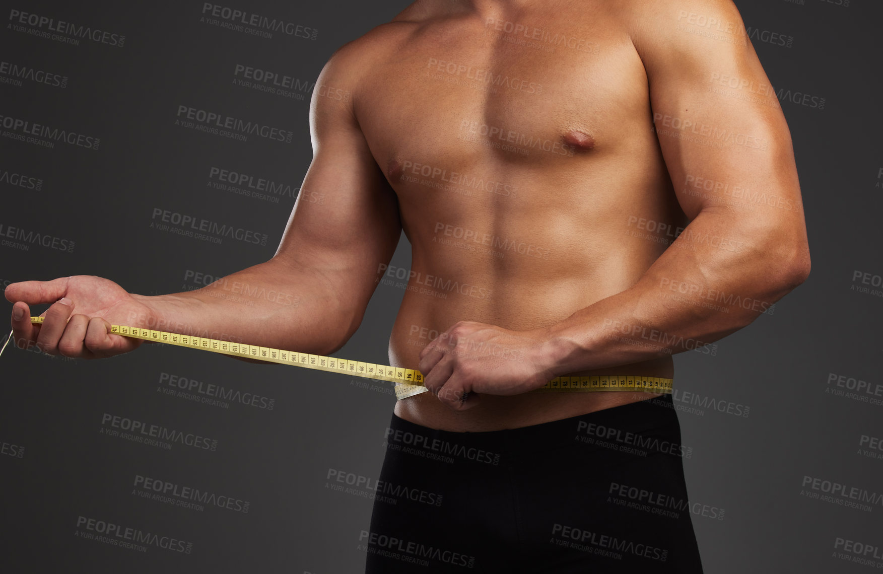 Buy stock photo Stomach, body and fitness man in studio with measuring tape for bodybuilding abs, goals and progress on black background. Muscle, sports and male athlete with sixpack measurement, growth or tracking