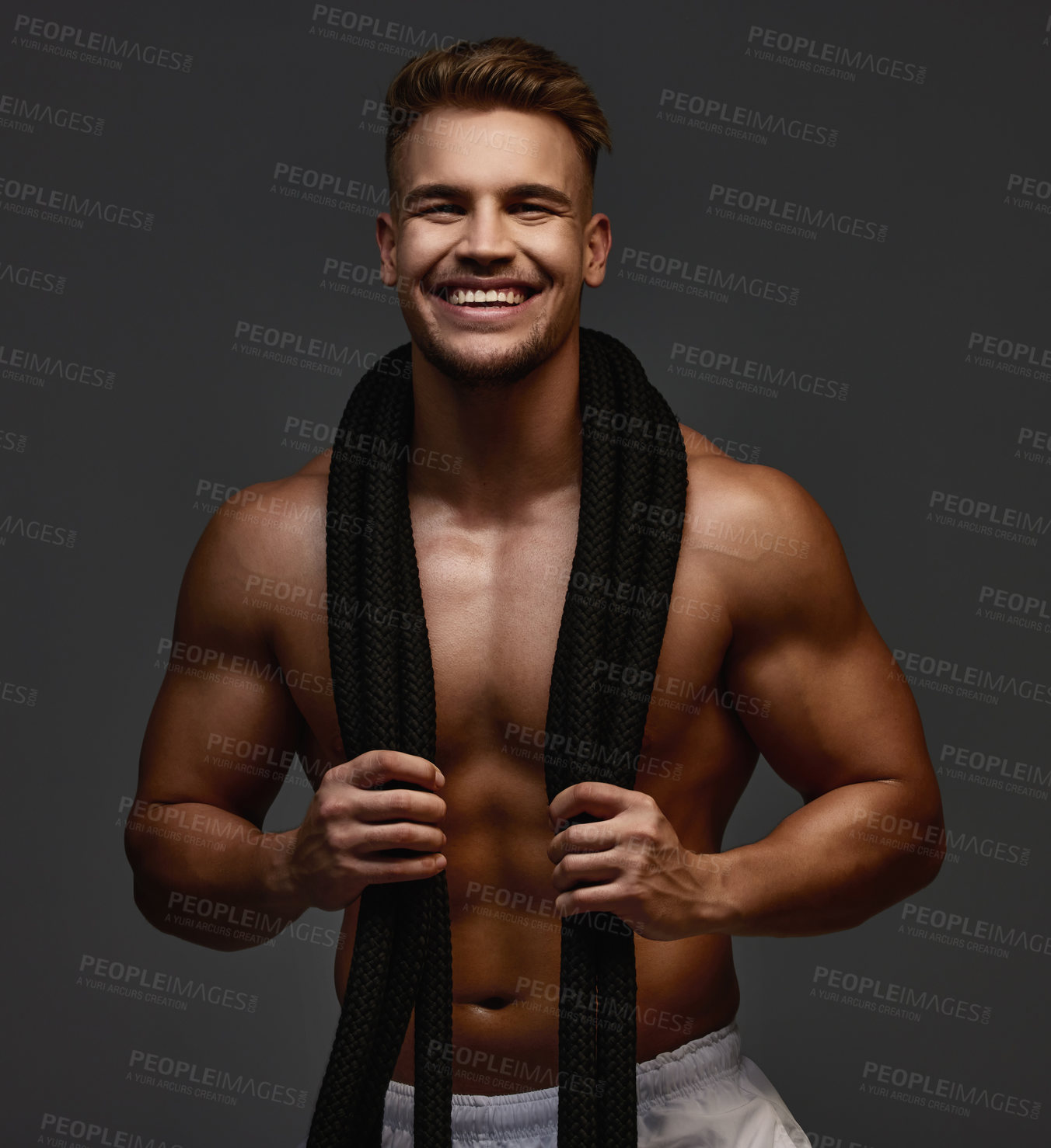 Buy stock photo Happy, portrait and bodybuilder with ropes in studio for exercise, training and fitness for health. Sportsman, athlete and shirtless for wellness by dark background for transformation and workout