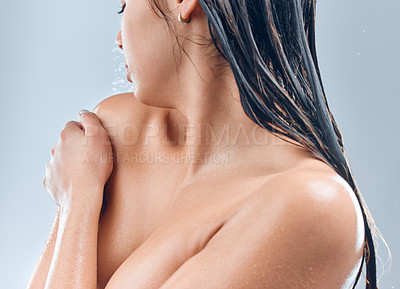 Buy stock photo Shot of a young woman in the shower against a grey background