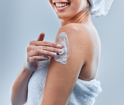 Buy stock photo Woman, skincare and lotion with body moisture for eczema, glow results and dermatology in studio. Product, model girl and apply cream or sunscreen for dry skin and morning routine by grey background