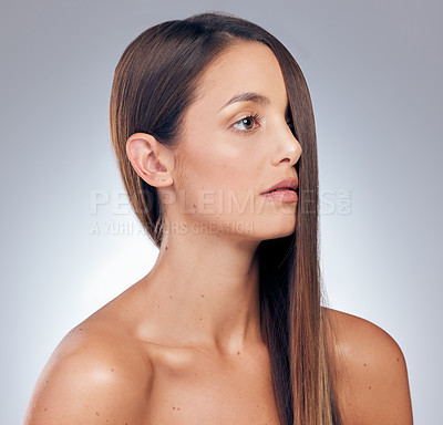Buy stock photo Shot of an attractive young woman standing alone in the studio and posing