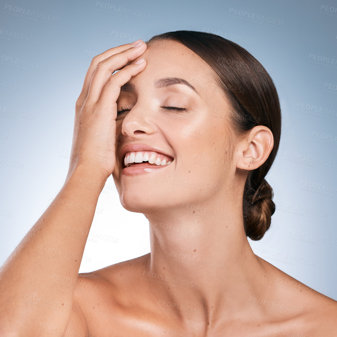 Buy stock photo Shot of a beautiful young woman posing against a blue background