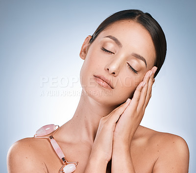 Buy stock photo Shot of a sleepy young woman showing her bedtime routine against a blue background