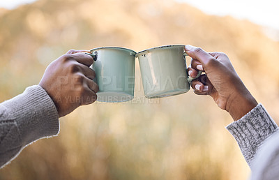 Buy stock photo Shot of a couple enjoying some coffee during a camping trip