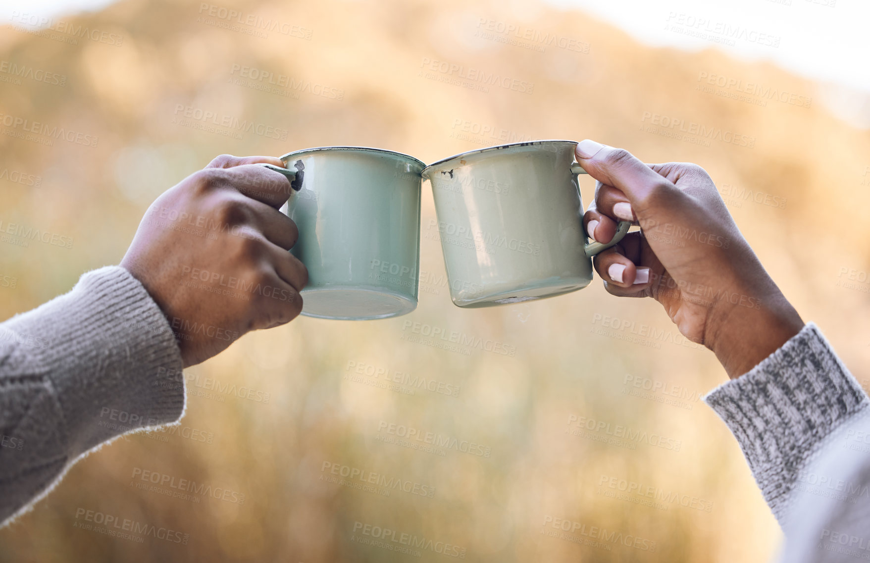 Buy stock photo Shot of a couple enjoying some coffee during a camping trip