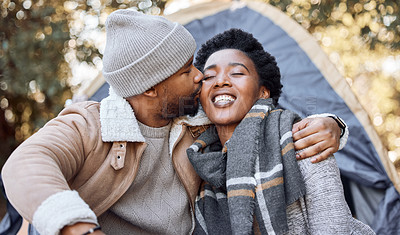 Buy stock photo Camping, happy and couple in nature kiss on holiday, vacation and adventure on weekend together. Relax, dating and black man and woman outdoors for bonding, loving relationship and chilling  by tent