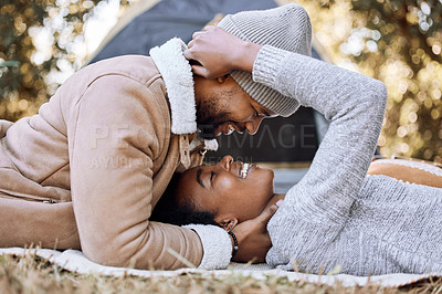 Buy stock photo Shot of a young couple spending quality time together while camping