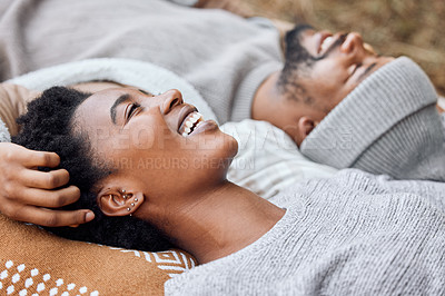 Buy stock photo Shot of a young couple lying down together while camping